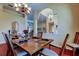 Dining room showcases hardwood floors, a dining table set for six, and views to other rooms at 2217 Windsong Ct, Safety Harbor, FL 34695