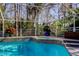 Beautiful in-ground pool and hot tub in screened enclosure at 2217 Windsong Ct, Safety Harbor, FL 34695