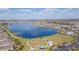 An aerial view of a community with a lake, walking path, park, and playground on a sunny day at 2334 Audubon Preserve Ln, Lutz, FL 33558