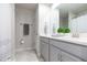 Bright bathroom features a double vanity with gray cabinets and decorative plants at 2334 Audubon Preserve Ln, Lutz, FL 33558