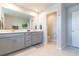 Bright bathroom with a double vanity, a large mirror and access to the toilet area at 2334 Audubon Preserve Ln, Lutz, FL 33558