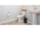 Clean half bathroom with a pedestal sink and neutral decor creates a functional and tidy space at 2334 Audubon Preserve Ln, Lutz, FL 33558