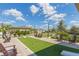 Beautiful community outdoor cornhole area with chairs, lighting, and well maintained landscaping at 2334 Audubon Preserve Ln, Lutz, FL 33558