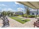 Outdoor cornhole area featuring turf, seating, and string lights, perfect for community fun at 2334 Audubon Preserve Ln, Lutz, FL 33558