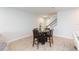 Dining room with wood look tile floors with views of stairs to second floor and front door at 2334 Audubon Preserve Ln, Lutz, FL 33558