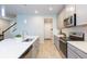 Modern kitchen with gray cabinets, stainless steel appliances, and quartz countertops at 2334 Audubon Preserve Ln, Lutz, FL 33558