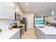 Modern kitchen with gray cabinets, stainless steel appliances, and quartz countertops at 2334 Audubon Preserve Ln, Lutz, FL 33558