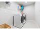 Well-lit laundry room with new washer and dryer and ample storage space at 2334 Audubon Preserve Ln, Lutz, FL 33558