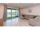 Bright living room with a large slider to screened porch, perfect for relaxing and entertaining at 2334 Audubon Preserve Ln, Lutz, FL 33558