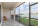 Screened patio with pavers overlooking a serene lake at 2334 Audubon Preserve Ln, Lutz, FL 33558