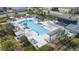 Aerial view of a resort-style pool area with ample lounge seating and lush landscaping at 2334 Audubon Preserve Ln, Lutz, FL 33558