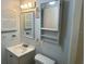 Compact bathroom offering a single vanity, mirrored cabinet and standard toilet at 24862 Us Highway 19 N # 1504, Clearwater, FL 33763