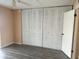 Bright room featuring fresh paint, wood-look floors, and multiple white closets for ample storage at 24862 Us Highway 19 N # 1504, Clearwater, FL 33763