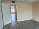 Bright room featuring fresh paint, wood-look floors, and an open closet for storage at 24862 Us Highway 19 N # 1504, Clearwater, FL 33763