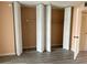 Bedroom featuring large closets with bi-fold doors and neutral walls at 24862 Us Highway 19 N # 1504, Clearwater, FL 33763