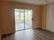 Bright room featuring fresh paint, wood-look floors and a sliding door to a screened patio at 24862 Us Highway 19 N # 1504, Clearwater, FL 33763