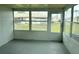 Enclosed porch featuring large windows and a door to the backyard at 24862 Us Highway 19 N # 1504, Clearwater, FL 33763