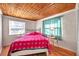 Cozy bedroom with wood ceiling, comfortable bed, and natural light at 2539 44Th S St, St Petersburg, FL 33711