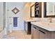 Bathroom featuring double vanity sinks, framed mirrors, and subway tile in the shower at 2985 W Knights Ave # 2985, Tampa, FL 33611