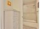 Bathroom featuring a white cabinet and an adjacent shower stall with glass doors at 2985 W Knights Ave # 2985, Tampa, FL 33611