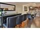 Chic dining area with a black bar and stools, leading to a modern kitchen and dining space with natural light at 2985 W Knights Ave # 2985, Tampa, FL 33611