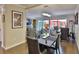 Elegant dining space with a black table and chairs, leading to a bright living area and outdoor patio at 2985 W Knights Ave # 2985, Tampa, FL 33611