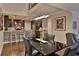 Contemporary dining area featuring a black glass table, stylish lighting, and an open view to the modern kitchen at 2985 W Knights Ave # 2985, Tampa, FL 33611