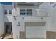 Modern two-story home featuring a balcony, white exterior, and attached garage at 2985 W Knights Ave # 2985, Tampa, FL 33611