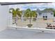 View of the property's exterior, showcasing palm trees and assigned parking at 2985 W Knights Ave # 2985, Tampa, FL 33611