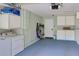 Spacious garage featuring a laundry area, storage cabinets, and access door at 2985 W Knights Ave # 2985, Tampa, FL 33611