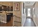 Entryway hallway with views of the kitchen featuring dark cabinetry and an island at 2985 W Knights Ave # 2985, Tampa, FL 33611