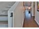 Bright hallway with wood floors, staircase with modern handrail, and view to the outdoor patio beyond at 2985 W Knights Ave # 2985, Tampa, FL 33611