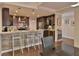 Modern kitchen featuring dark wood cabinets, stainless steel appliances, and a stylish breakfast bar at 2985 W Knights Ave # 2985, Tampa, FL 33611