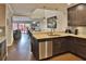 Open-concept kitchen with stainless steel appliances, granite countertops, and a seamless flow to the dining area at 2985 W Knights Ave # 2985, Tampa, FL 33611