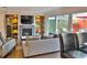 Comfortable living room featuring a fireplace, entertainment center, and access to a charming outdoor patio at 2985 W Knights Ave # 2985, Tampa, FL 33611