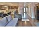 Spacious living room featuring a gray sofa, leather chair, and a view of the kitchen and dining area at 2985 W Knights Ave # 2985, Tampa, FL 33611