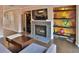 Stylish living room with a modern fireplace, built-in shelves, and a wine fridge for entertaining at 2985 W Knights Ave # 2985, Tampa, FL 33611