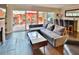 Cozy living room with a gray sofa, leading to an outdoor patio with seating and a grill at 2985 W Knights Ave # 2985, Tampa, FL 33611