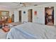 Spacious main bedroom featuring a walk-in closet, a work desk, and a comfortable king-size bed with natural light at 2985 W Knights Ave # 2985, Tampa, FL 33611