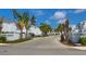A street view of a residential community with palm trees and well-maintained landscaping at 2985 W Knights Ave # 2985, Tampa, FL 33611