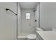 Shower featuring marble tile with bronze showerhead, toilet, and partial view of vanity at 3213 King William Cir, Seffner, FL 33584