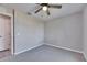 Bedroom featuring gray walls, carpet, ceiling fan, and white trim at 3213 King William Cir, Seffner, FL 33584