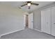 Bright bedroom featuring gray walls, carpet, ceiling fan, and closet at 3213 King William Cir, Seffner, FL 33584