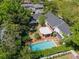 Stunning aerial view of backyard oasis, showcasing a large swimming pool, covered patio, and lush landscaping on a sunny day at 3412 W Mckay Ave, Tampa, FL 33609