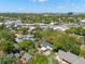 Aerial view showcases a home with a pool and well-maintained landscaping, surrounded by lush greenery and neighborhood streets at 3412 W Mckay Ave, Tampa, FL 33609