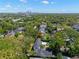Aerial view shows the property nestled in a tree-filled residential neighborhood with a nearby swimming pool at 3412 W Mckay Ave, Tampa, FL 33609