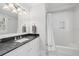 Traditional bathroom with marble countertop vanity and shower and tub combination at 3412 W Mckay Ave, Tampa, FL 33609