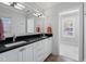 Bright bathroom with double sink, modern fixtures, and a view to the next room at 3412 W Mckay Ave, Tampa, FL 33609
