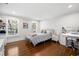Cozy bedroom with hardwood floors, bright windows, and comfortable furnishings at 3412 W Mckay Ave, Tampa, FL 33609