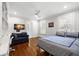 Sunlit bedroom with hardwood floors, comfortable seating, and bright windows at 3412 W Mckay Ave, Tampa, FL 33609